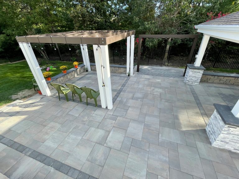 Example of a backyard concrete paver patio kitchen design in DC Metro