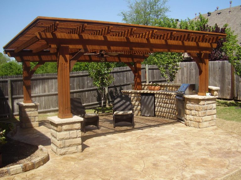 Example of a backyard patio kitchen design in Indianapolis with a pergola