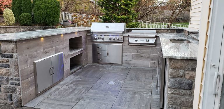 Example of a backyard patio kitchen design in New York