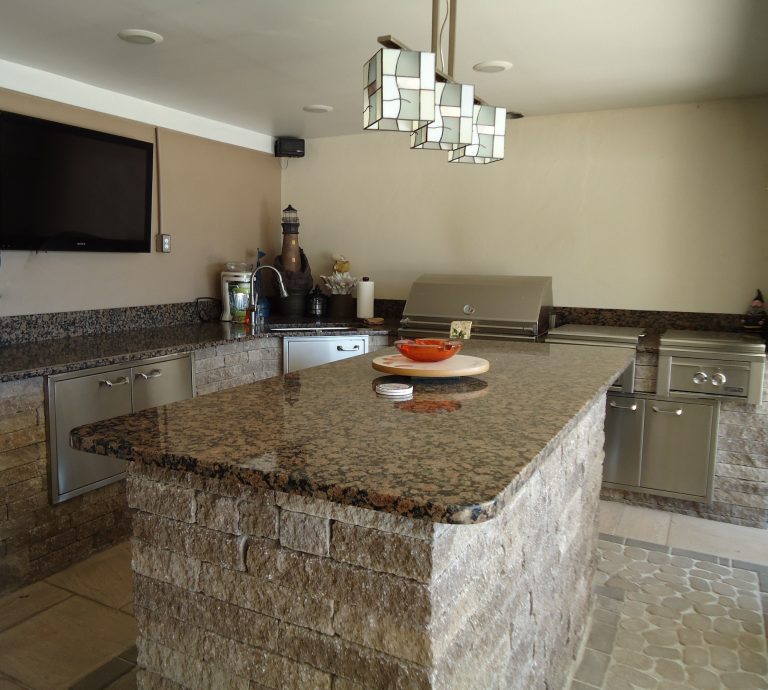 Example of a backyard patio kitchen design in Other with a roof extension