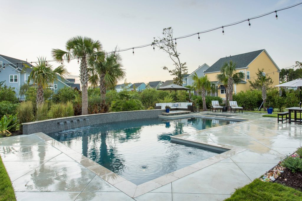 Example of a beach style backyard concrete and custom-shaped lap pool fountain design in Charleston