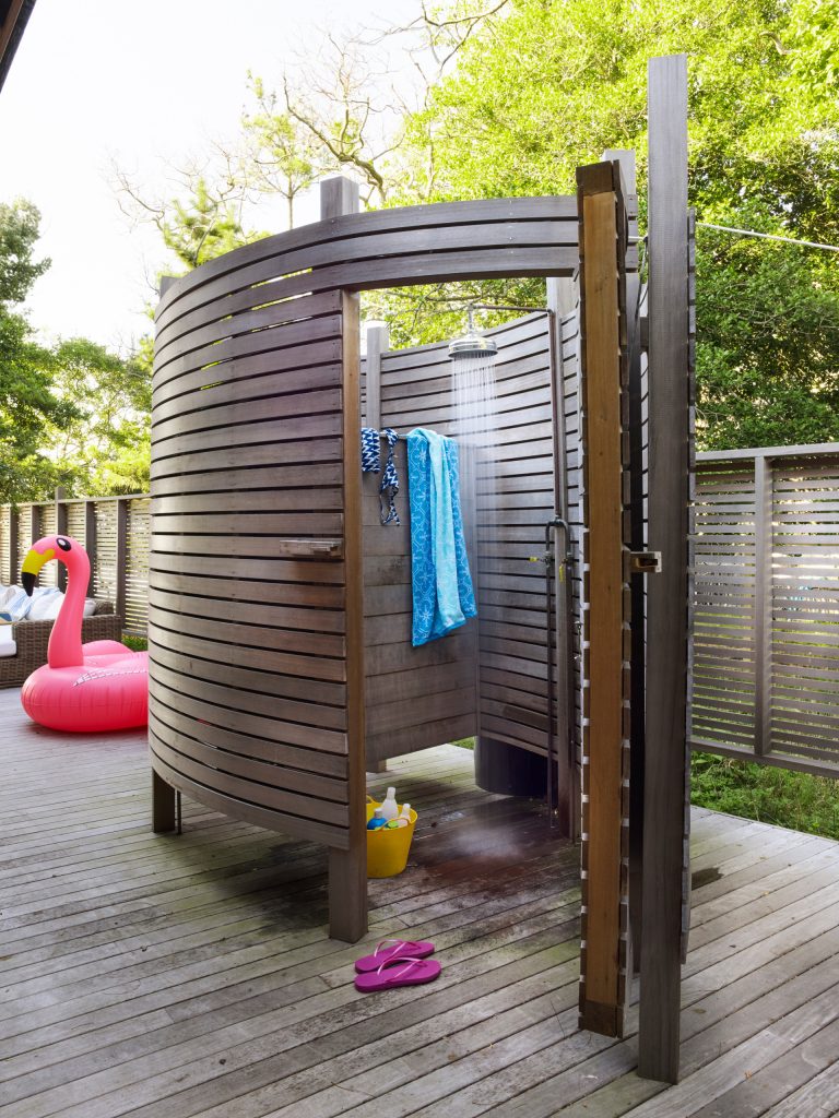 Example of a beach style outdoor shower deck design in Boston with no cover