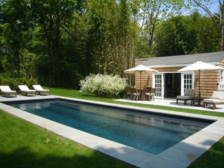 Example of a beach style pool house design in New York