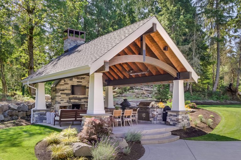 Example of a classic backyard concrete patio kitchen design in Seattle with a gazebo