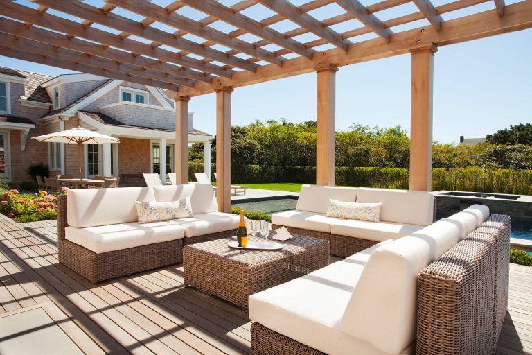 Example of a classic backyard deck design in Providence with a pergola