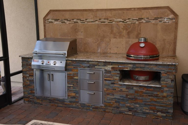 Example of a classic backyard outdoor kitchen deck design in Jacksonville with a roof extension