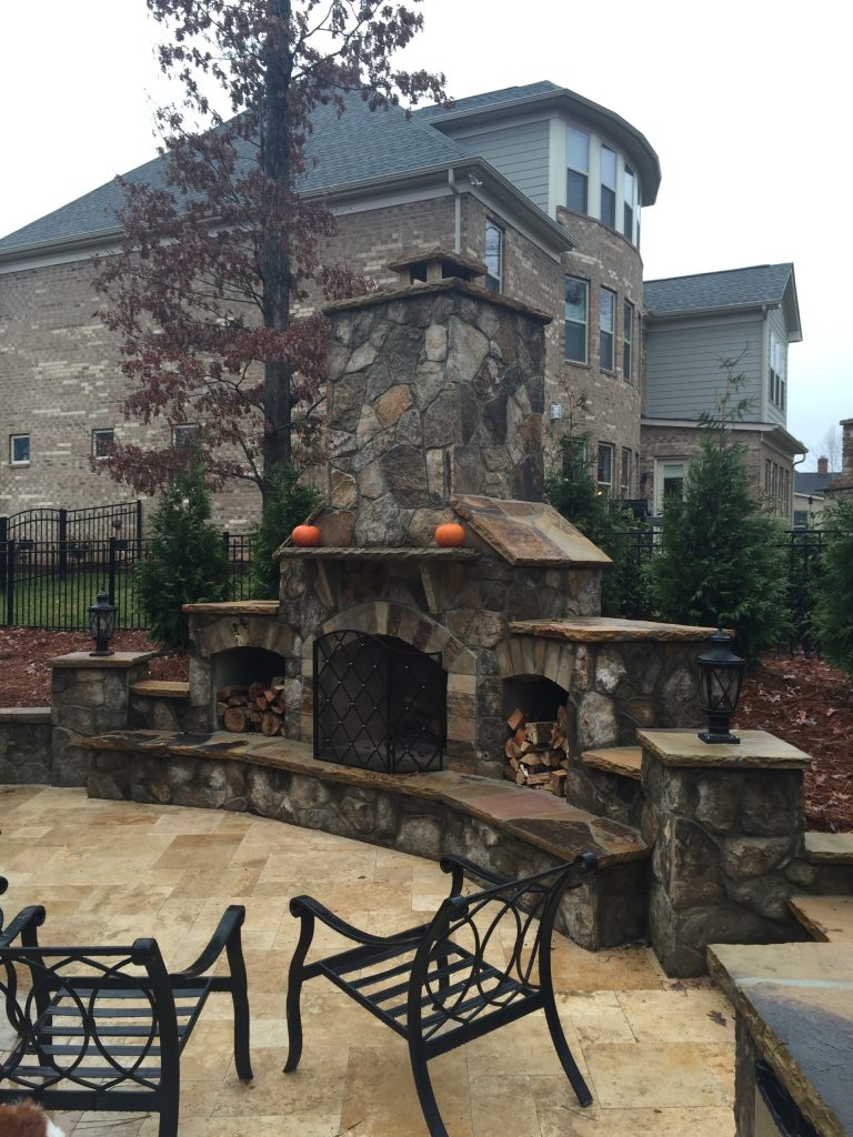 Example of a classic backyard patio kitchen design in Charlotte with no cover