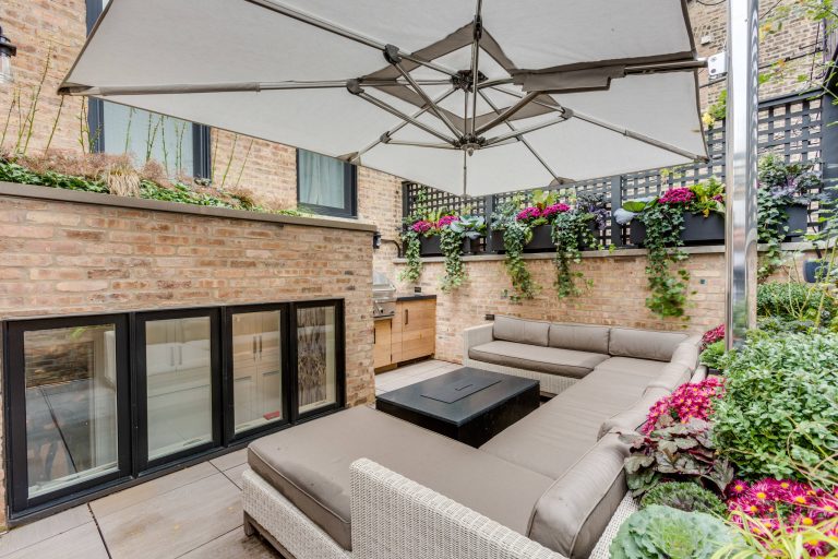 Example of a classic backyard patio kitchen design in Chicago with an awning