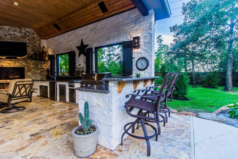 Example of a classic backyard patio kitchen design in Houston with a gazebo
