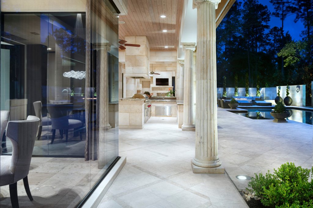 Example of a classic backyard patio kitchen design in Houston with a roof extension