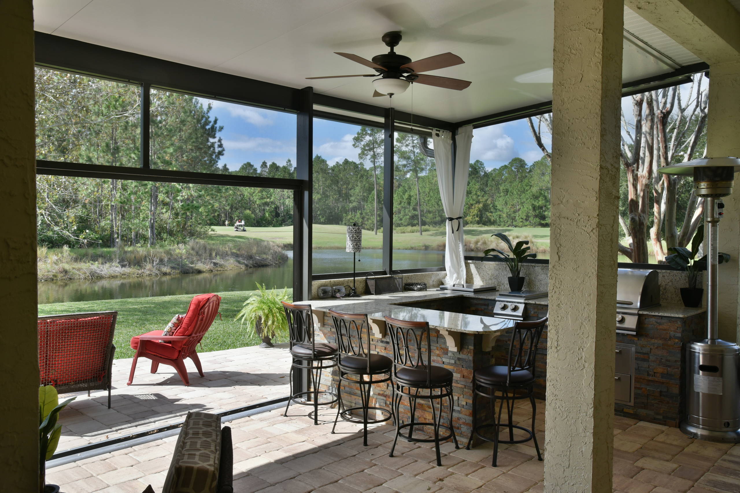 Example of a classic outdoor kitchen deck design in Jacksonville with a roof extension