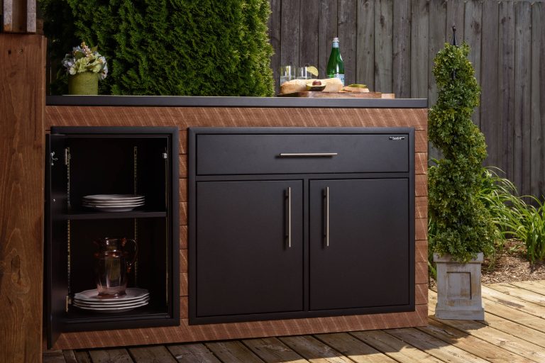 Example of a classic side yard stamped concrete patio kitchen design in Other with no cover