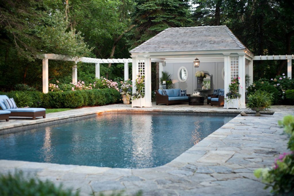 Example of a classic stone and rectangular pool design in New York
