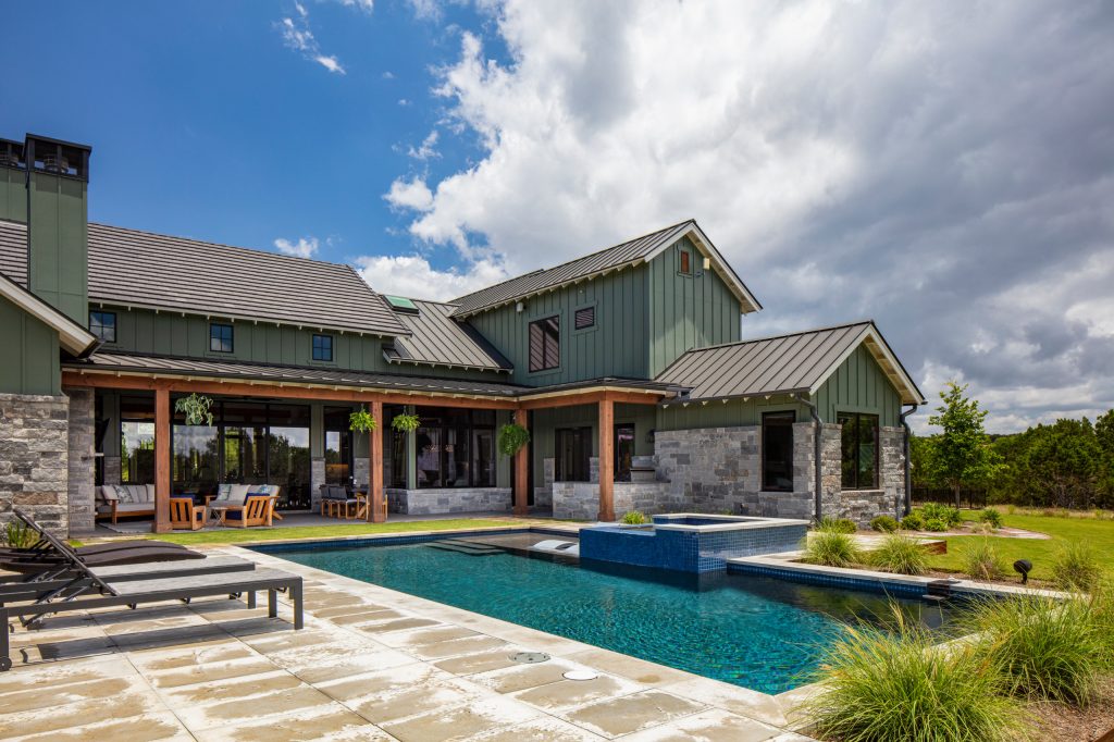 Example of a country backyard concrete paver and rectangular hot tub design in Austin