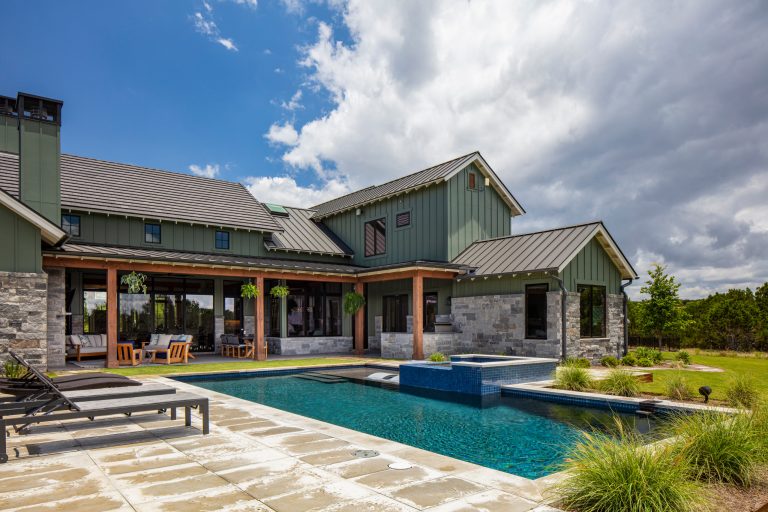 Example of a country backyard concrete paver and rectangular hot tub design in Austin