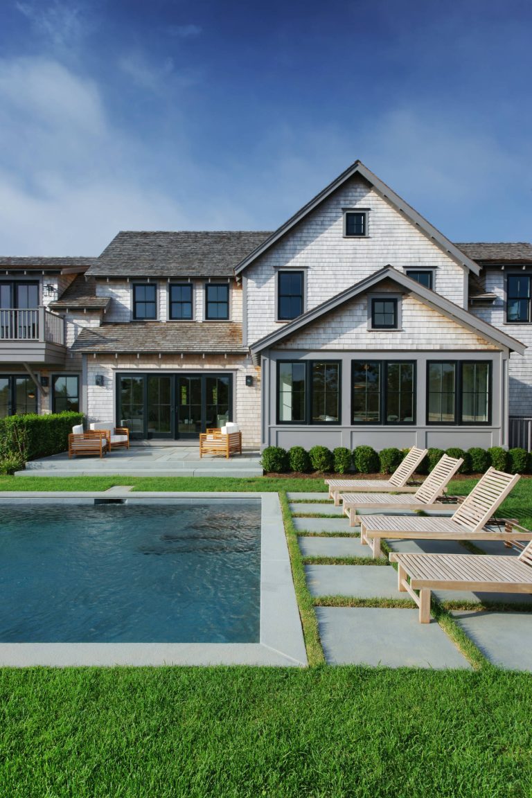 Example of a country backyard stone and rectangular pool design in Boston