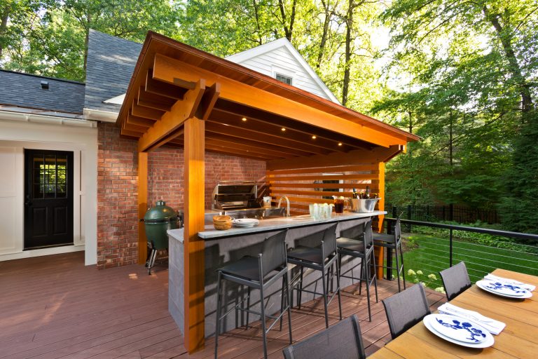 Example of a huge classic backyard outdoor kitchen deck design in Boston with a pergola