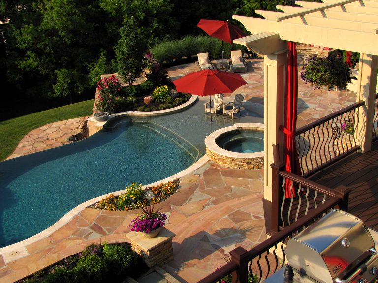 Example of a huge classic backyard stone and custom-shaped lap hot tub design in New York