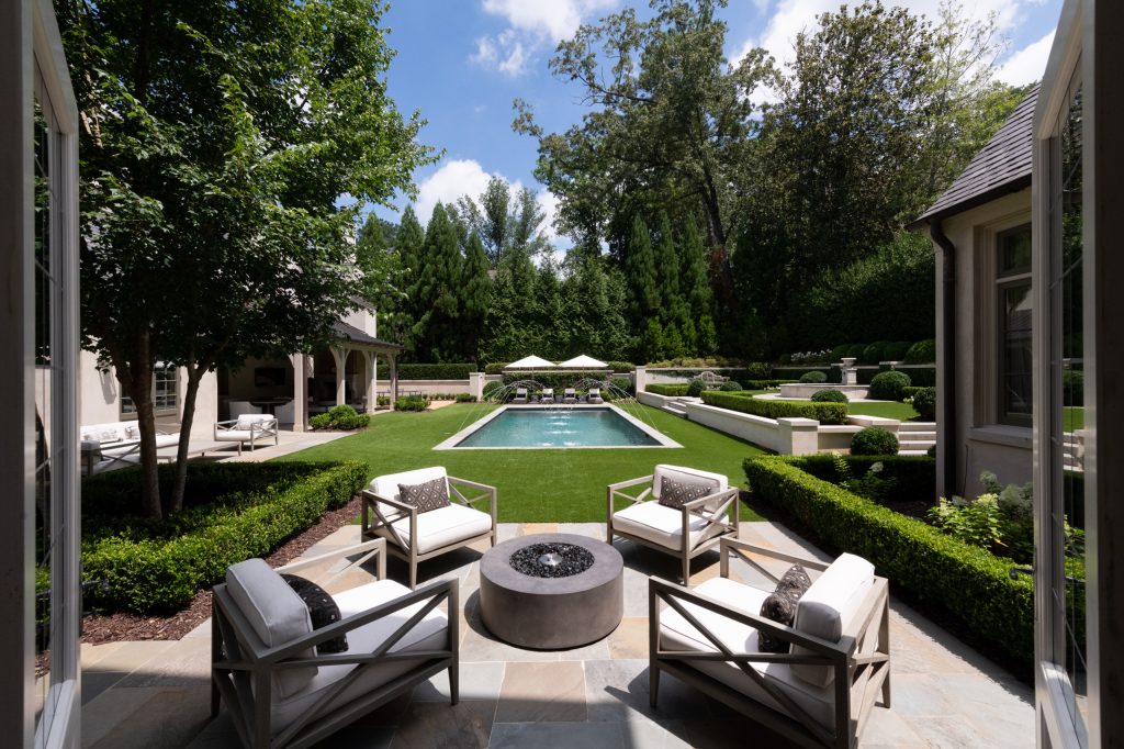Example of a huge classic backyard stone and rectangular lap pool fountain design in Atlanta