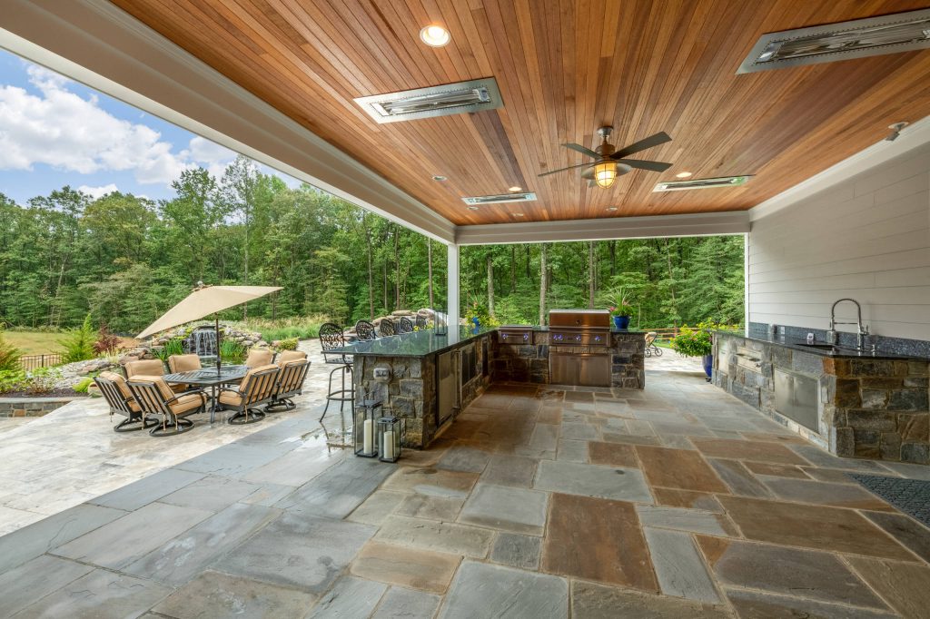 Example of a huge classic backyard tile patio kitchen design in Baltimore with no cover