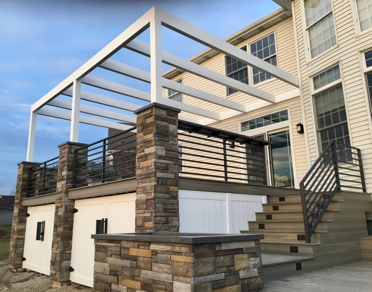 Example of a huge minimalist backyard outdoor kitchen deck design in Austin with a pergola