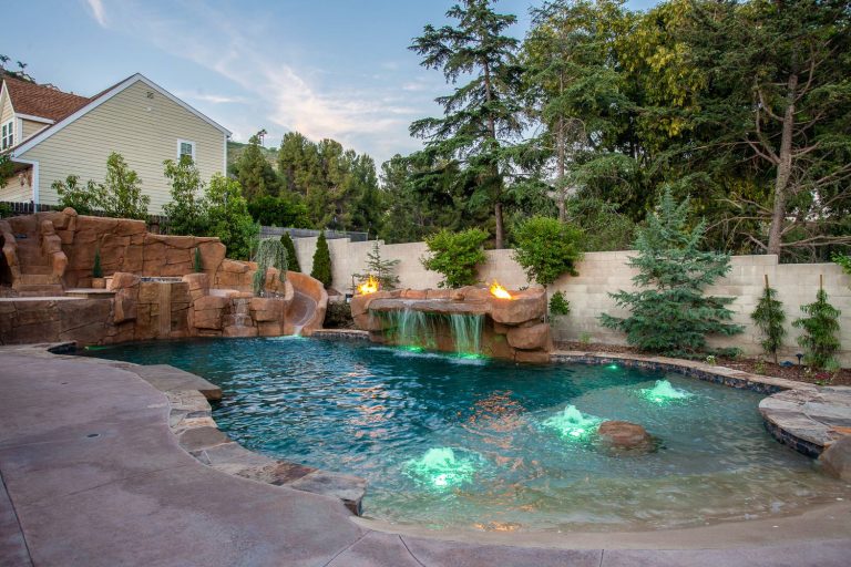 Example of a huge mountain style backyard concrete and custom-shaped natural pool fountain design in Orange County