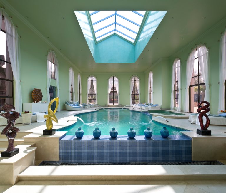 Example of a huge ornate indoor tile and custom-shaped lap pool fountain design in Miami