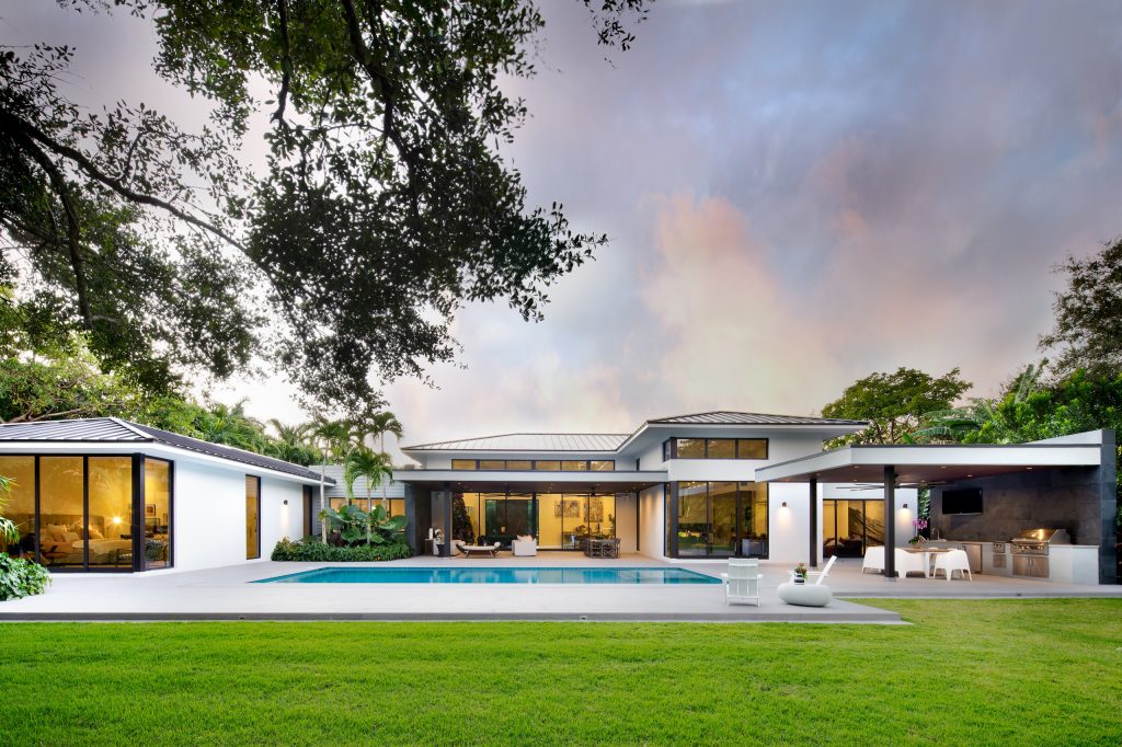 Example of a huge trendy backyard concrete patio kitchen design in Miami