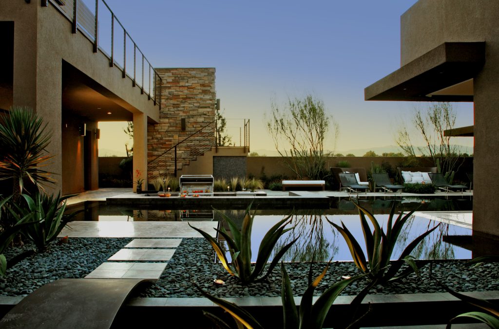 Example of a huge trendy backyard custom-shaped infinity pool design in Las Vegas