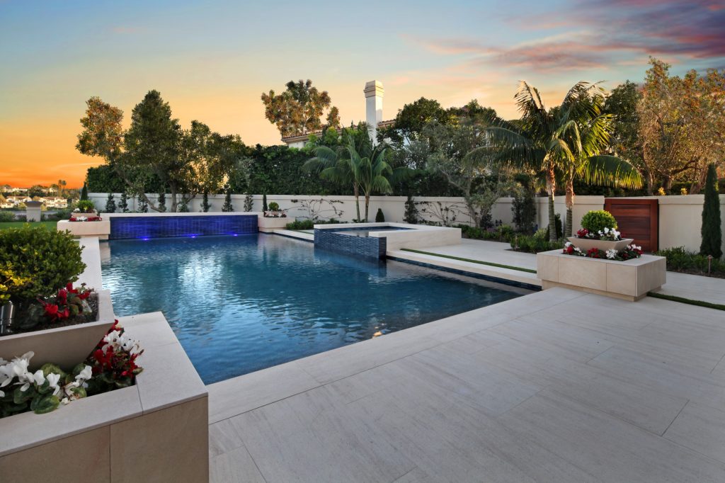 Example of a huge trendy backyard stone and rectangular hot tub design in Orange County