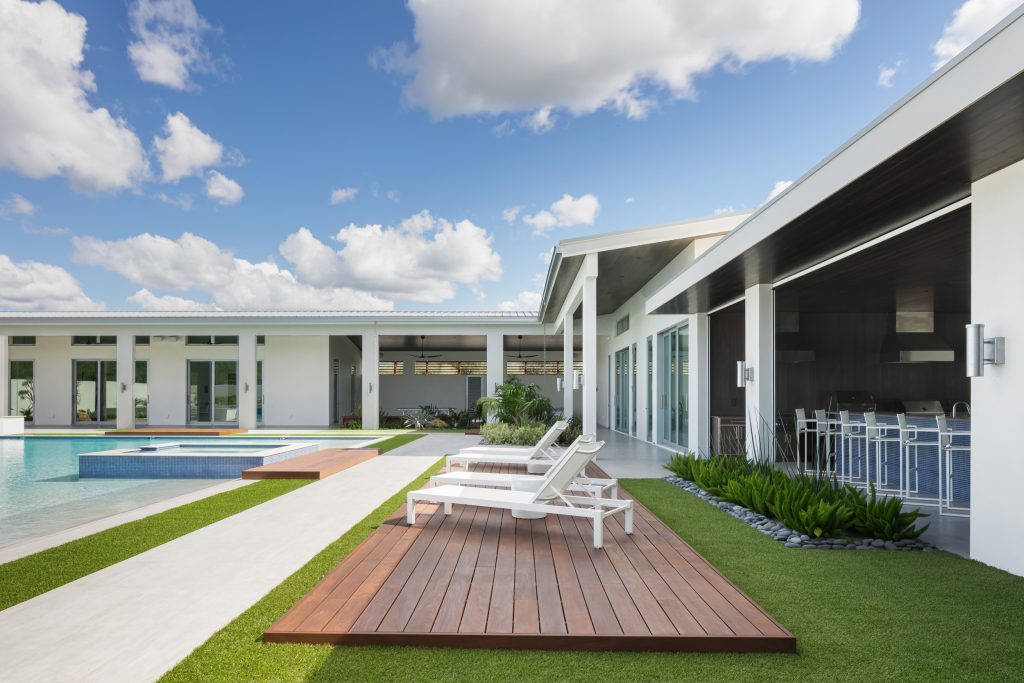 Example of a huge trendy backyard tile and custom-shaped lap hot tub design in Tampa