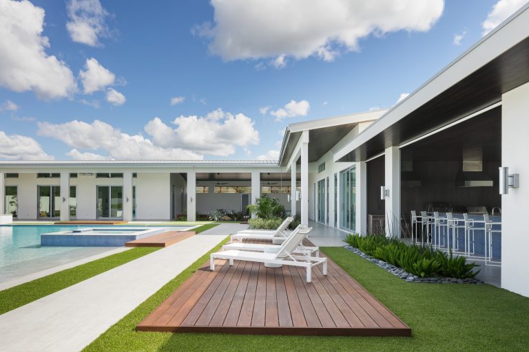 Example of a huge trendy backyard tile and custom-shaped lap hot tub design in Tampa
