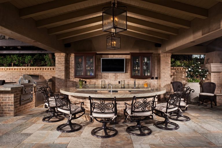Example of a huge tuscan backyard stone patio kitchen design in Orange County with a gazebo