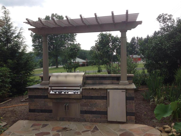 Example of a large arts and crafts backyard brick patio kitchen design in Cleveland with a pergola