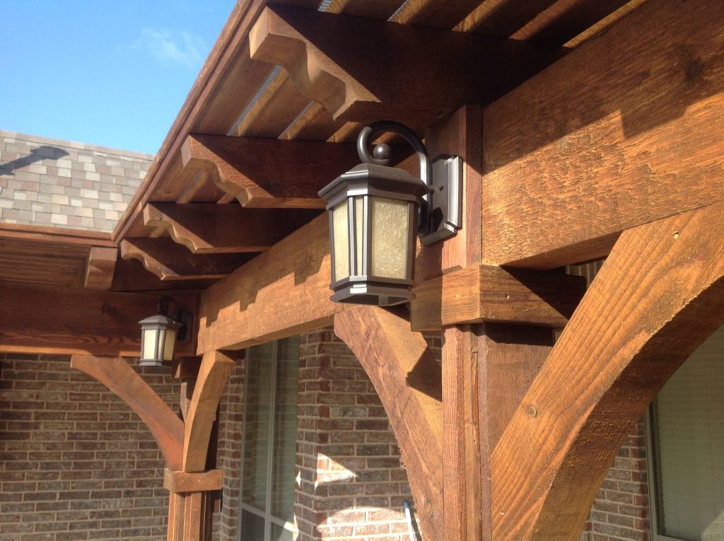 Example of a large arts and crafts backyard concrete patio kitchen design in Dallas with a pergola