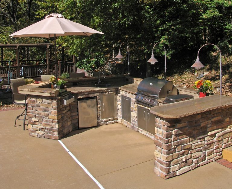 Example of a large arts and crafts backyard concrete patio kitchen design in St Louis