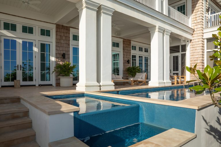 Example of a large beach style backyard concrete paver and rectangular natural hot tub design in Other