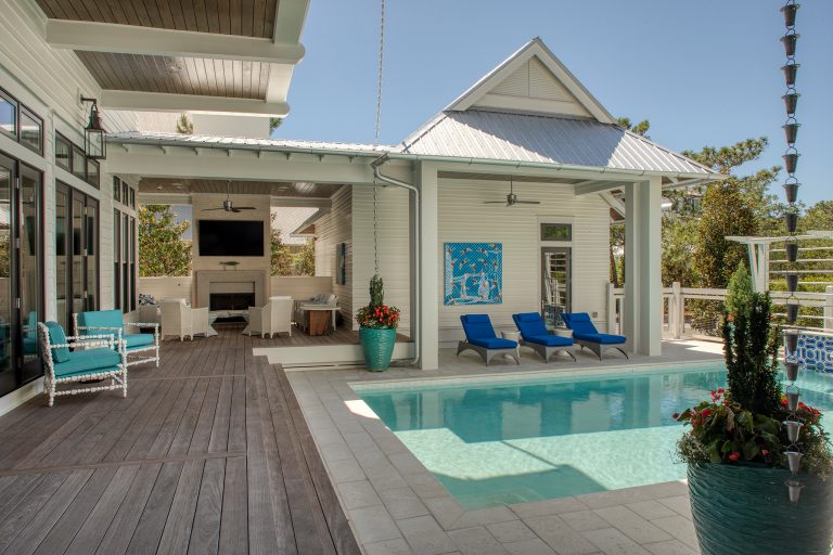Example of a large beach style backyard concrete paver and rectangular natural pool house design in Other
