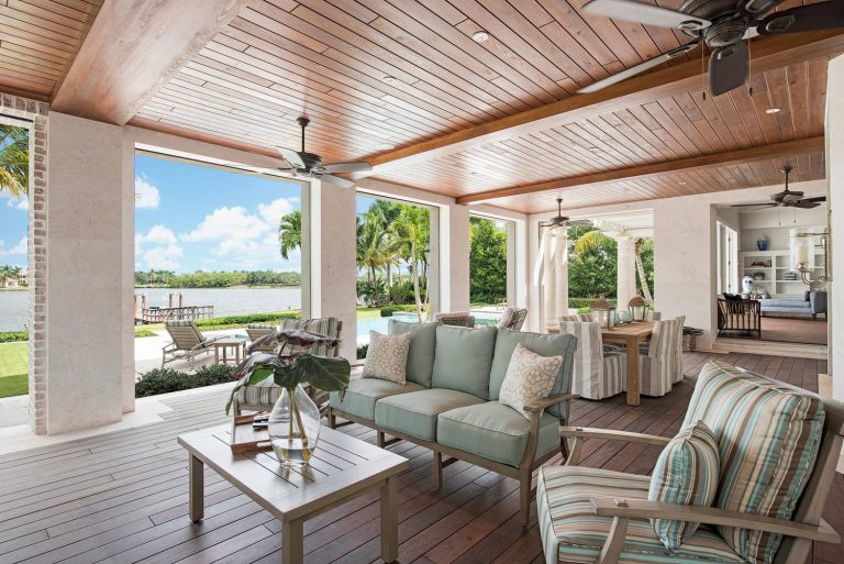 Example of a large beach style backyard outdoor kitchen deck design in Miami with a roof extension