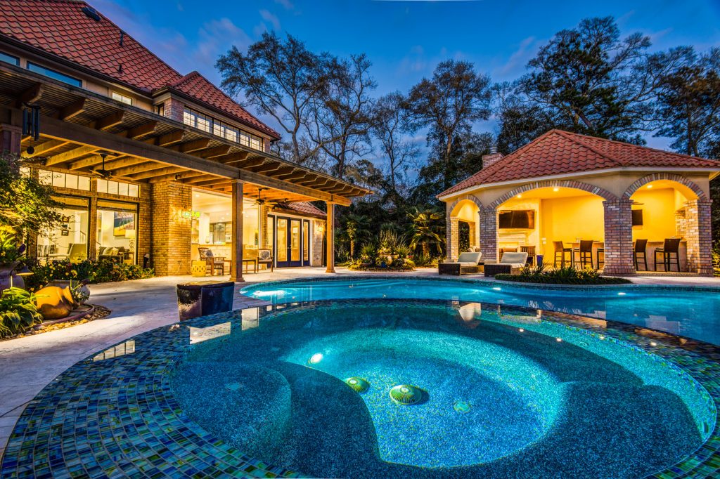 Example of a large beach style backyard stone patio kitchen design in Houston with a gazebo