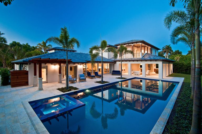 Example of a large beach style backyard tile and rectangular pool design in Miami
