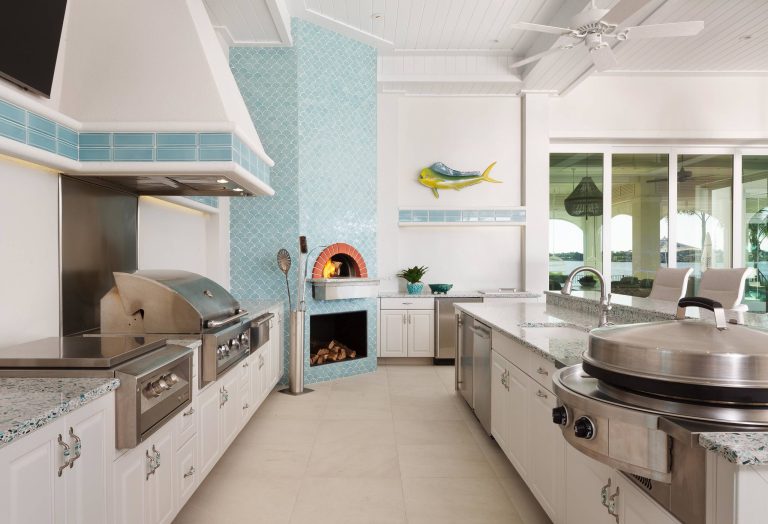 Example of a large beach style backyard tile patio kitchen design in Miami with a roof extension