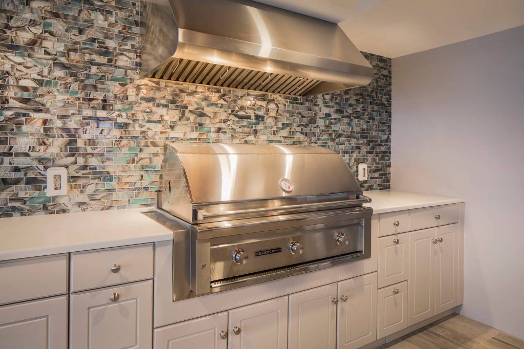 Example of a large beach style backyard tile patio kitchen design in Philadelphia with a roof extension