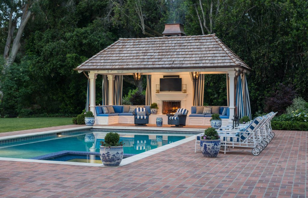 Example of a large classic backyard brick and rectangular lap pool house design in San Francisco