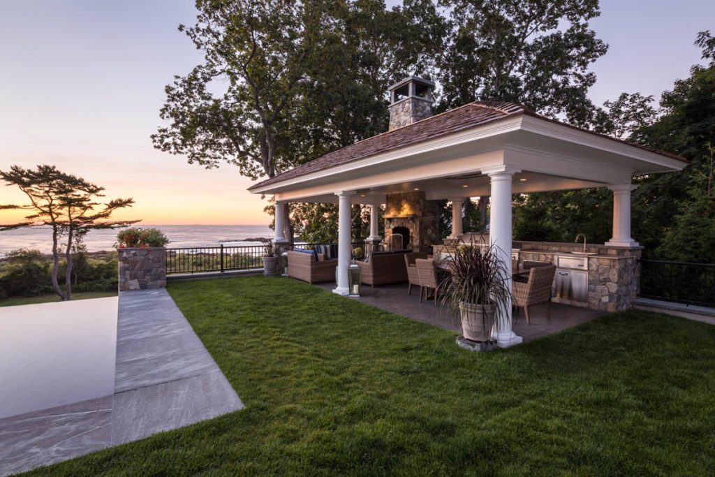 Example of a large classic backyard concrete patio kitchen design in Portland Maine with a gazebo