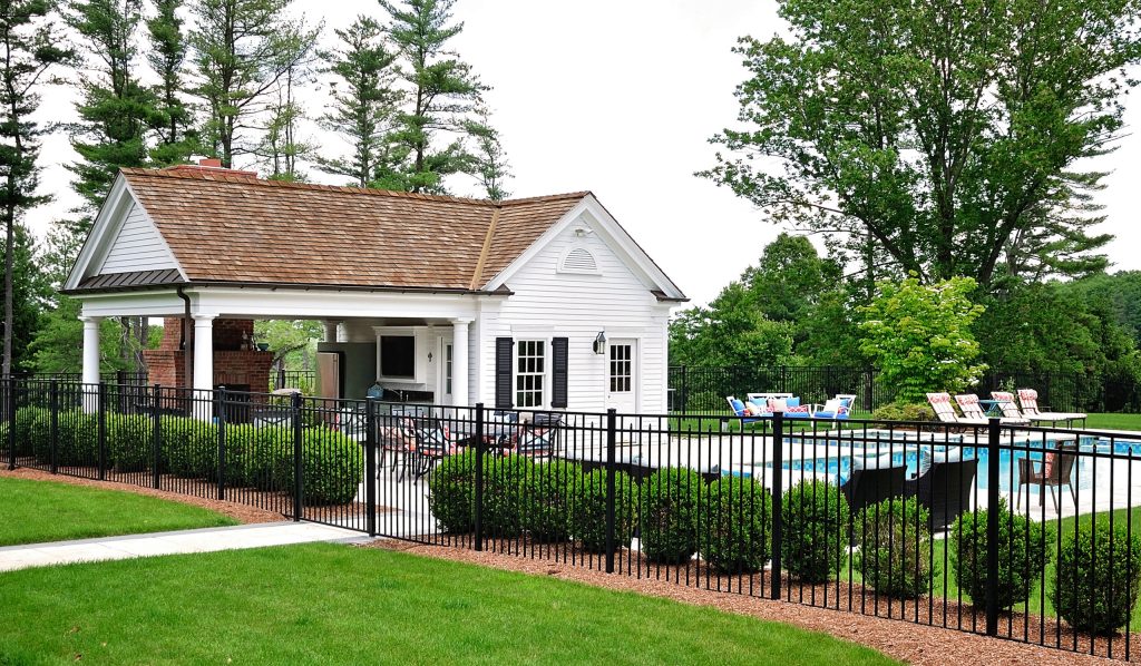 Example of a large classic backyard concrete paver and rectangular lap pool house design in New York