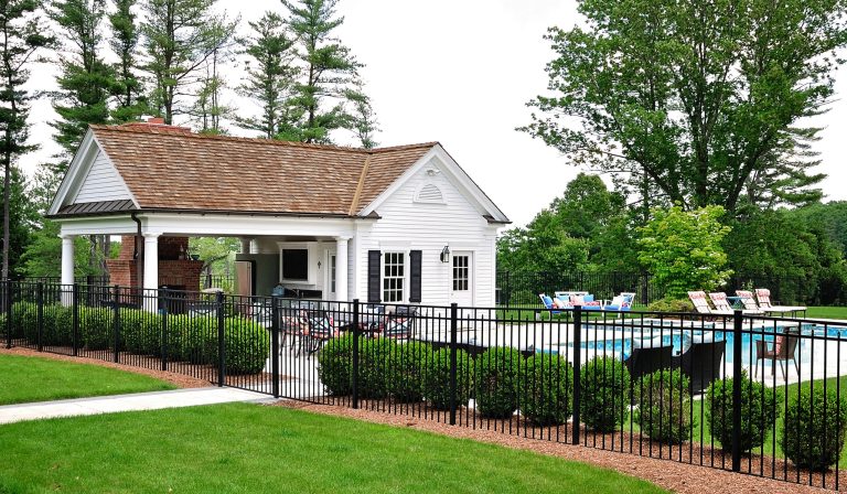 Example of a large classic backyard concrete paver and rectangular lap pool house design in New York