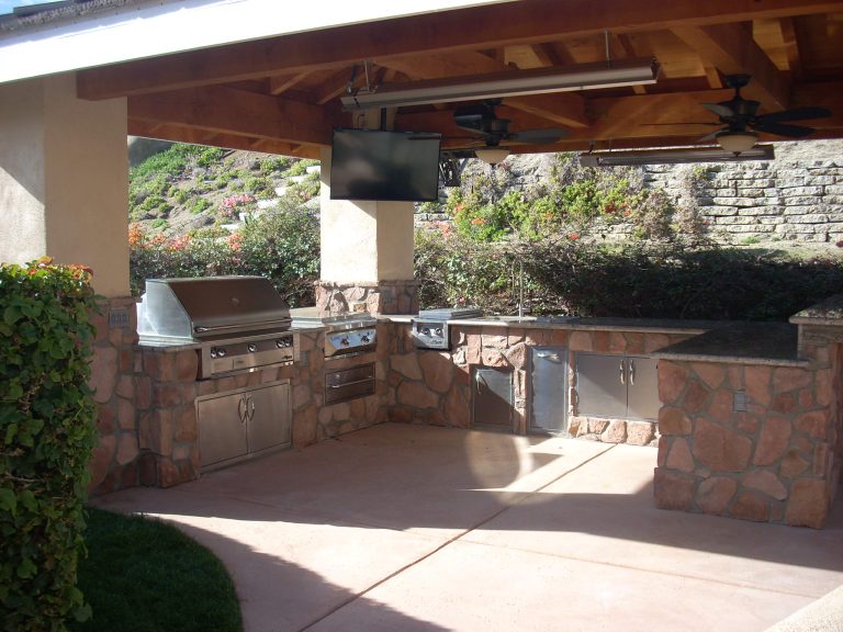 Example of a large classic backyard concrete paver patio kitchen design in Los Angeles with a gazebo