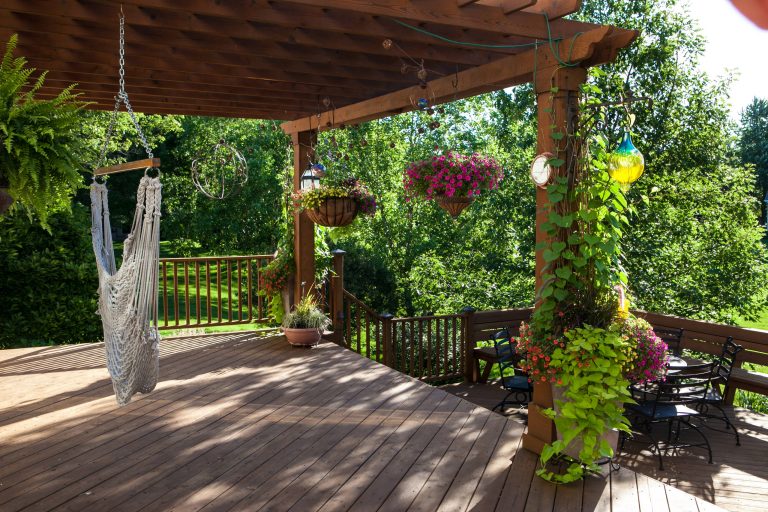 Example of a large classic backyard deck design in Chicago with a pergola