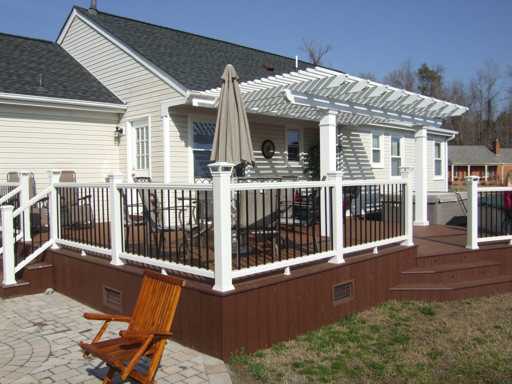 Example of a large classic backyard deck design in Other with a pergola